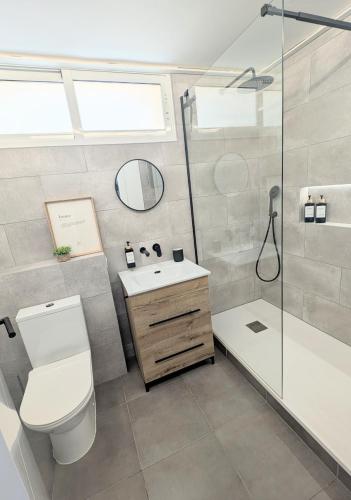 a bathroom with a toilet and a shower and a sink at Loft with Private Pool in Alzira in Alzira