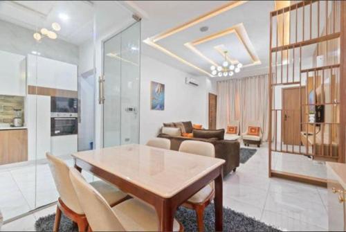 a living room with a table and a couch at Olive apartment in Maiyegun