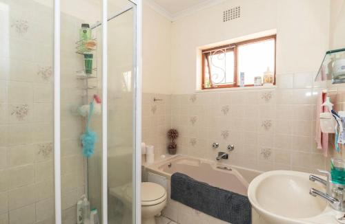 a bathroom with a toilet and a sink and a shower at Sunset Nest in Meadowridge
