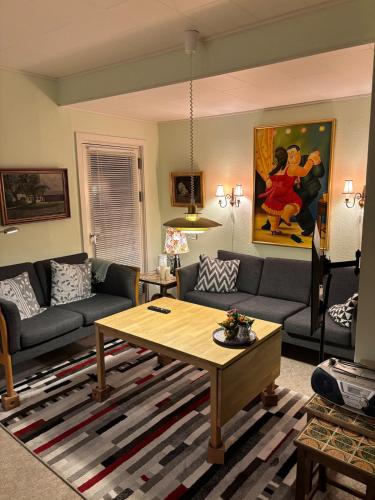 a living room with a couch and a table at Apartment 2 min from airport 10 min to city in Copenhagen