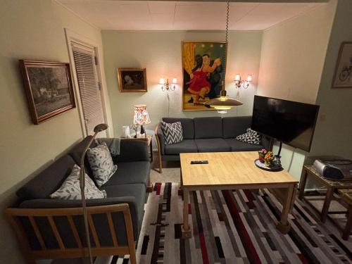 a living room with a couch and a table at Apartment 2 min from airport 10 min to city in Copenhagen