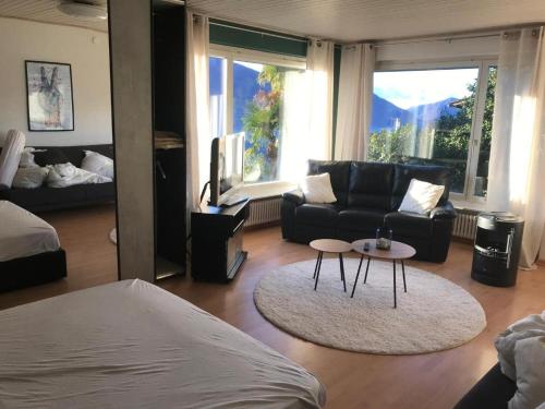 a living room with a couch and a table at Girasole Orselina in Orselina