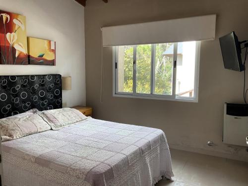 a bedroom with a bed and a window at Pax Costa del Este - Pax Suites in Costa del Este