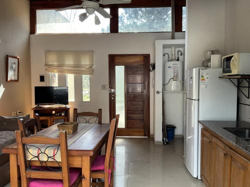 a kitchen and dining room with a table and refrigerator at Pax Costa del Este - Pax Suites in Costa del Este