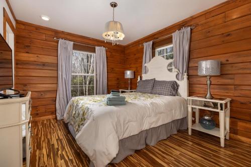 a bedroom with wooden walls and a bed and a window at Lakin' it Easy! - Powder Horn Mountain in Powderhorn Mountain