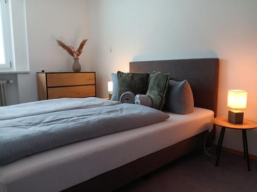 a bedroom with a bed with a lamp on it at Ferienwohnung Landliebe in Pinswang