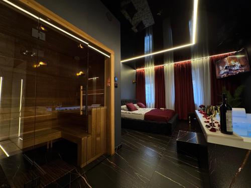 a room with a bed and a tub in a room at Moon Luxury Apartment - Jacuzzi & Sauna in Wałbrzych