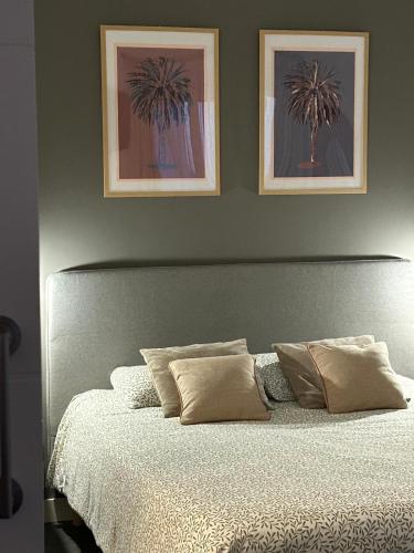 a bedroom with a bed with two pictures on the wall at Las Dunas Blancas - Roof Top - by FTV Holidays Homes in Villaverde