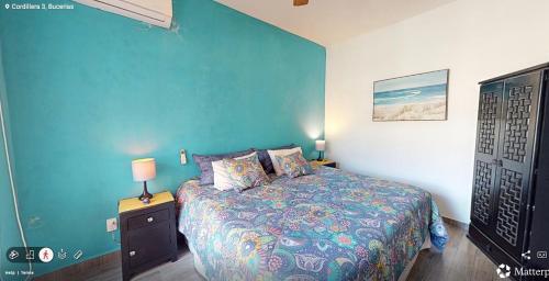 a bedroom with a bed and a blue wall at Best area and ocean view in Cruz de Huanacaxtle
