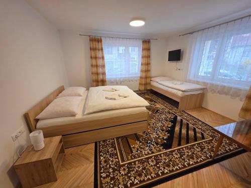 a small room with a bed and a couch at Vila Daniela in Luhačovice