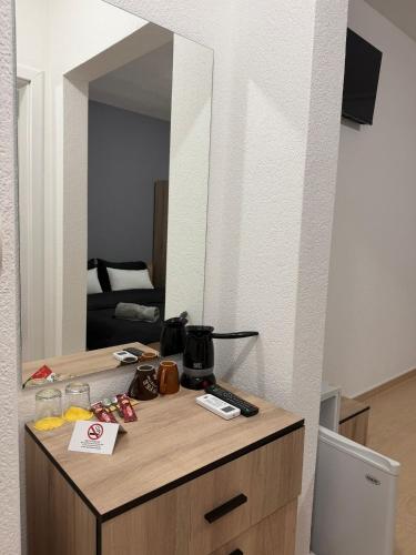 a mirror on top of a dresser in a room at Luxury Apartments Miranda in Ohrid