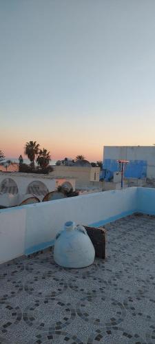 a vase sitting on the ground next to a wall at Dar Sonia in Hammamet