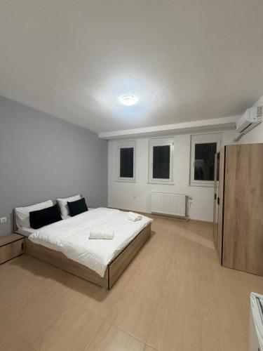 a bedroom with a large white bed and two windows at Luxury Apartments Miranda in Ohrid