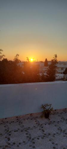 a view of the sunset from a balcony of a building at Dar Sonia in Hammamet