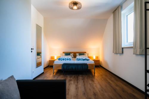 a bedroom with a bed and a couch and a window at Seethal in Laufen