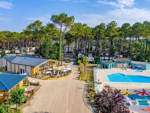 an aerial view of a resort with a pool and a building at Les dunes de contis- landes in Saint-Julien-en-Born