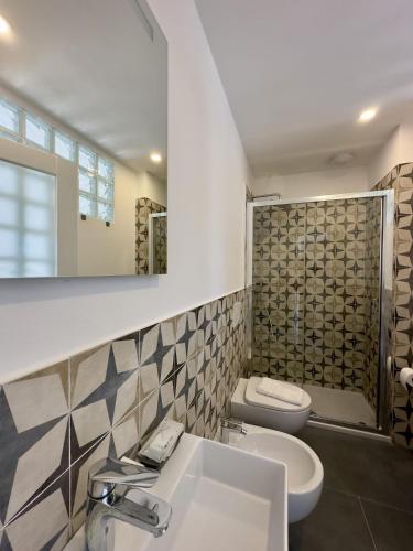 a bathroom with a sink and a toilet and a mirror at Affittacamere Giulia in Vernazza