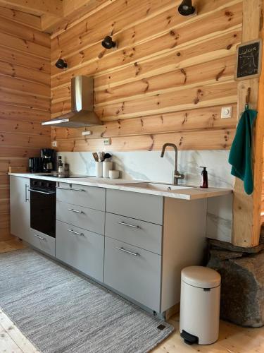a kitchen with a sink and a stove at Deer Cottage in Sylte