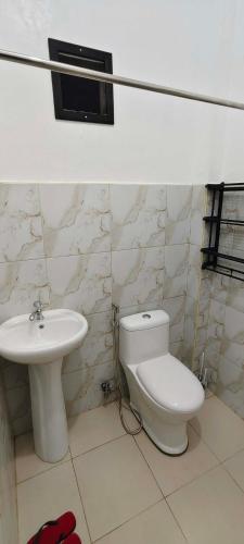 a bathroom with a toilet and a sink at Amor apartment in Coron