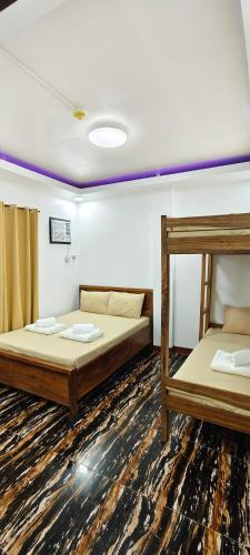 a room with two bunk beds in it at Amor apartment in Coron