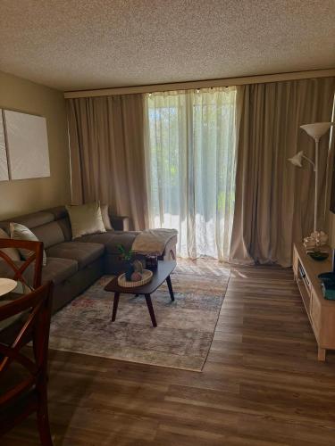a living room with a couch and a table at Casa SolMar in Fort Pierce