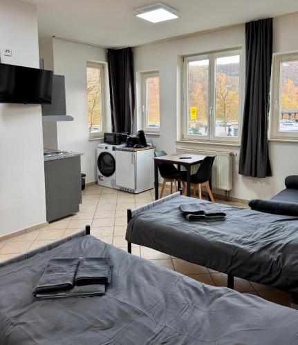a living room with two beds and a kitchen at Apartment-Herrlingen in Blaustein