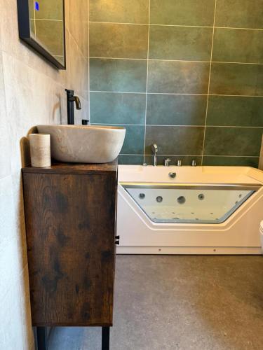 a bathroom with a tub and a sink at Chic and Chill Guest House, gite Safari in Vallon-Pont-dʼArc