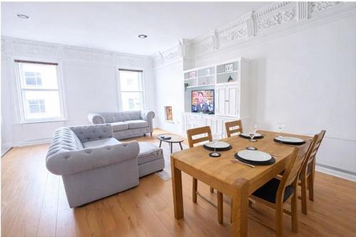a living room with a table and a couch at The Athenaeum in Sunderland