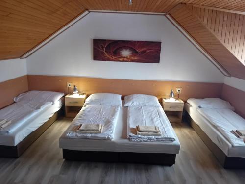 a room with two beds and two lights on the wall at Rekreacny Dom in Strečno