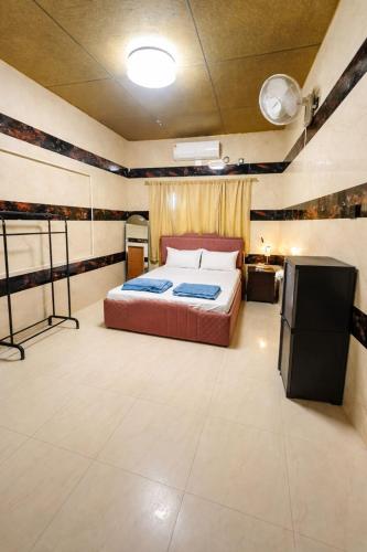 a bedroom with a bed and a television in it at W H Nest Hostel in Cochin