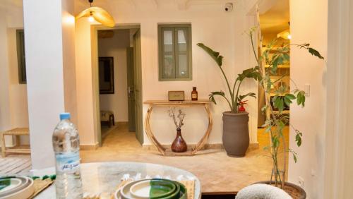 a living room with a table and a mirror at Riad Yamat privatisé au cœur de la Médina 3 chambres 10 min Jemaa el-Fna in Marrakesh