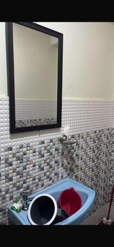 a bathroom with a sink and a mirror in it at Lhamus homestay in Tawang