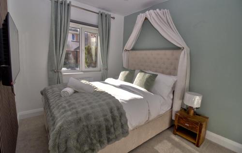 a bedroom with a canopy bed and a window at Luxurious, private rooms in the heart of Galway in Galway