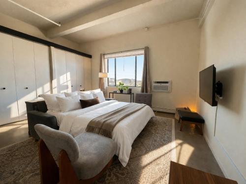 a bedroom with a large bed and a television at Westown Studio Apt Near Fiserv, Baird, and Theater District in Milwaukee