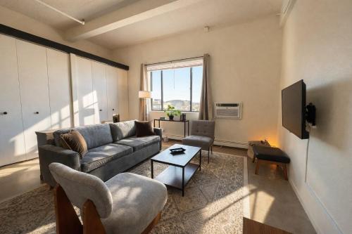 a living room with a couch and a tv at Westown Studio Apt Near Fiserv, Baird, and Theater District in Milwaukee
