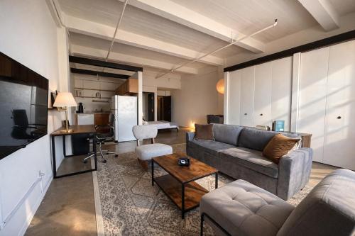 a living room with a couch and a table at Westown Studio Apt Near Fiserv, Baird, and Theater District in Milwaukee