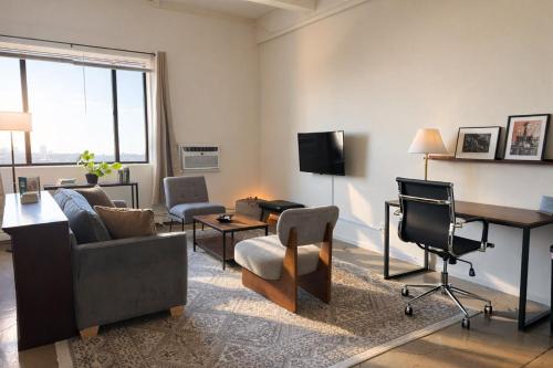 a living room with a couch and a table and chairs at Westown Studio Apt Near Fiserv, Baird, and Theater District in Milwaukee
