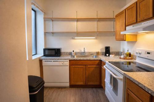a small kitchen with a sink and a microwave at Westown Studio Apt Near Fiserv, Baird, and Theater District in Milwaukee