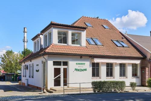 a white building with a red roof at Garnet Penzion in Olomouc