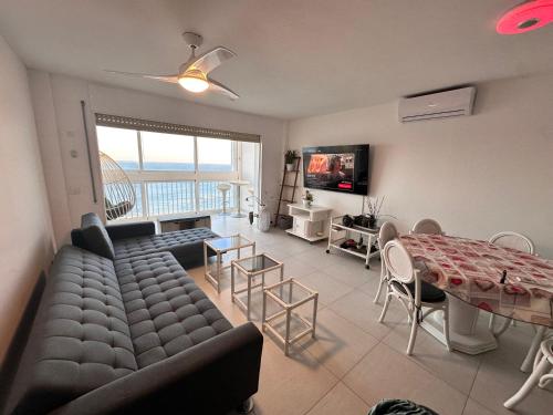 a living room with a couch and a table at Manhattan apartment in Empuriabrava