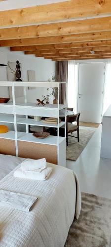 a bedroom with a white bed and a desk at TuksandDutsMeppel in Meppel