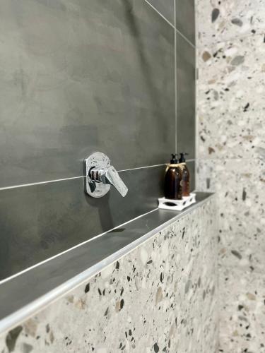 a bathroom sink with a faucet on a counter at Makiti Retreat in Polokwane
