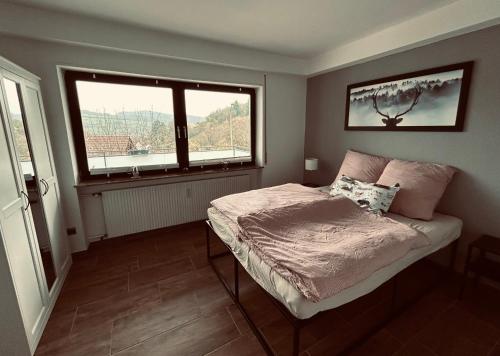 a small bedroom with a bed and a window at FeWo Wanderlustig in Wolfstein