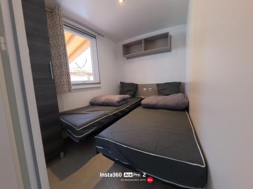 a room with two beds and a window at La Carabasse / Mazet 69 in Vias