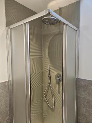 a shower with a glass door in a bathroom at Case di Daniela in Chiavari