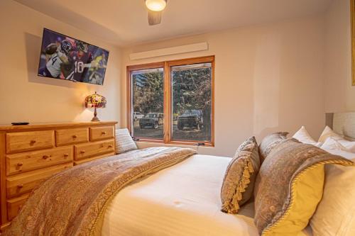 a bedroom with a bed with a dresser and a window at Sun Valley Condo 123 in Ketchum