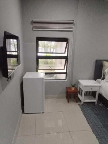 a room with a white refrigerator and a window at Peaceful Nest in St Lucia