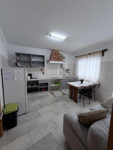 a kitchen with a couch and a table in a room at Lagos City Center Guest House & Hostel in Lagos