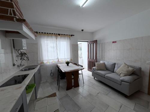 a kitchen and living room with a couch and a table at Lagos City Center Guest House & Hostel in Lagos