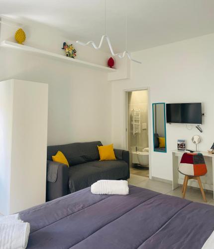 a living room with a bed and a couch at Cleli in Giardini Naxos